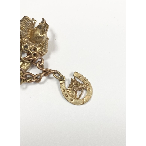 26 - A BEAUTIFUL 9CT YELLOW GOLD CHARM BRACELET, the chain is 9ct gold marked 375, with a wonderful array... 