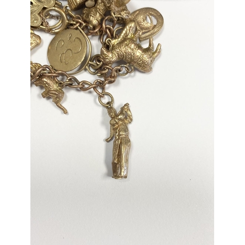 26 - A BEAUTIFUL 9CT YELLOW GOLD CHARM BRACELET, the chain is 9ct gold marked 375, with a wonderful array... 