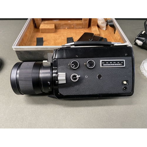 261 - A VINTAGE CASED ELMO SUPER 108 CAMERA, complete with lenses and attachments as photographed. ALONG W... 