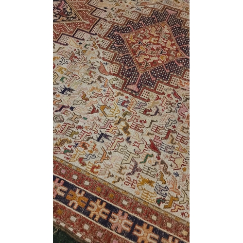 27 - A BEAUTIFUL HANDWOVEN IRANIAN KILIM FLOOR RUG, with a pair of large medallions one to each end with ... 