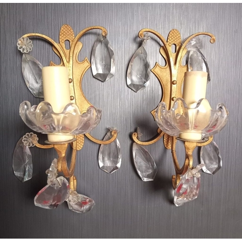 282 - A PAIR OF EARLY 20TH CENTURY FRENCH GILT BRASS WALL LIGHTS, each with cut glass pear shaped ornament... 