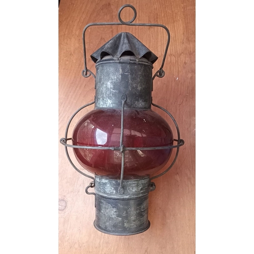 285 - AN ORIGINAL EARLY 20TH CENTURY (WORLD WAR I) SHIPS LAMP, with ruby glass shade and oil burner. Dimen... 