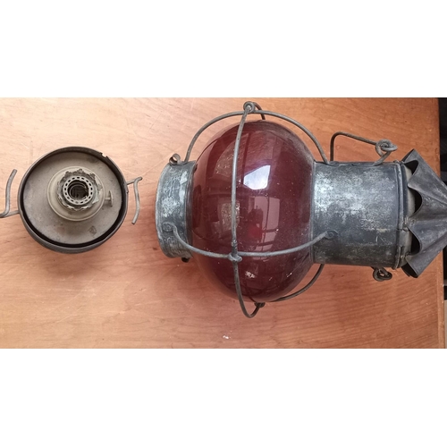 285 - AN ORIGINAL EARLY 20TH CENTURY (WORLD WAR I) SHIPS LAMP, with ruby glass shade and oil burner. Dimen... 