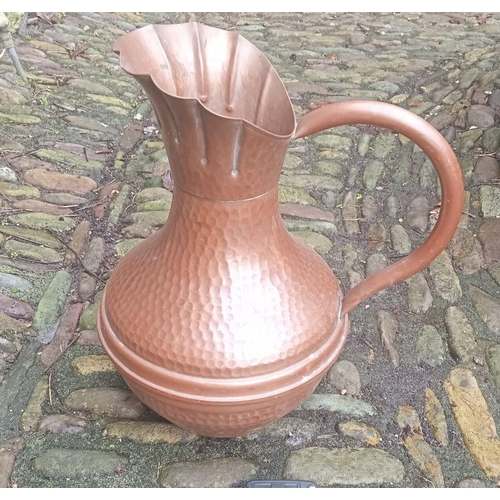 291 - A LARGE COPPER ARTS AND CRAFTS JUG, with hammered design to body