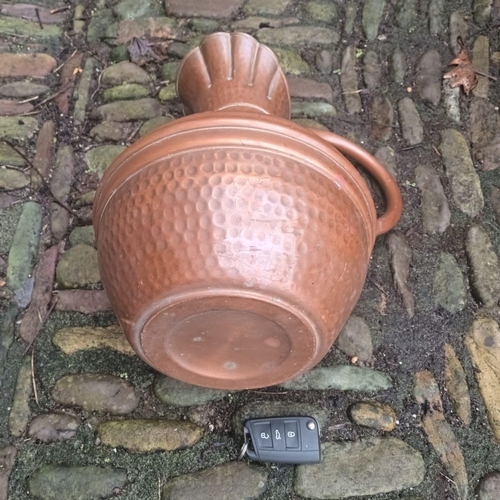 291 - A LARGE COPPER ARTS AND CRAFTS JUG, with hammered design to body