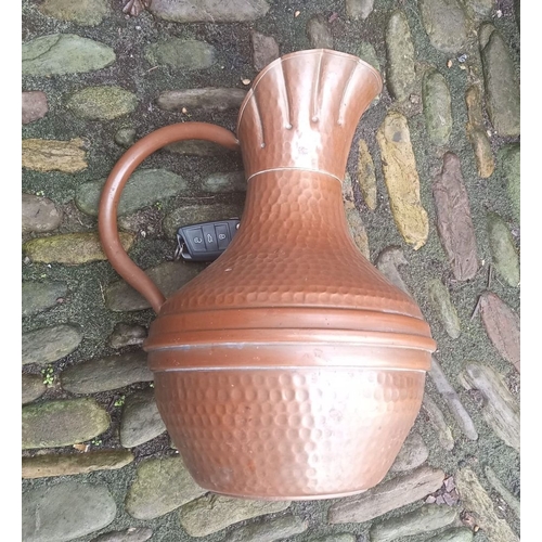 291 - A LARGE COPPER ARTS AND CRAFTS JUG, with hammered design to body