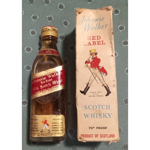 295 - A VINTAGE MINIATURE JOHNNIE WALKER RED LABEL WHISKY BOTTLE, complete with original box, seal intact