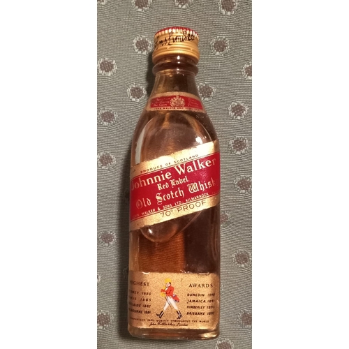 295 - A VINTAGE MINIATURE JOHNNIE WALKER RED LABEL WHISKY BOTTLE, complete with original box, seal intact