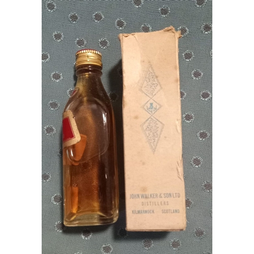 295 - A VINTAGE MINIATURE JOHNNIE WALKER RED LABEL WHISKY BOTTLE, complete with original box, seal intact