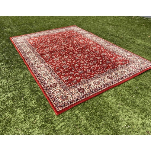 313 - A VIBRANT TURKISH STYLE RUG, excellent quality, the centre with foliate designs on red ground, surro... 