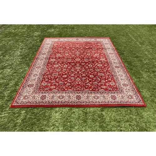 313 - A VIBRANT TURKISH STYLE RUG, excellent quality, the centre with foliate designs on red ground, surro... 