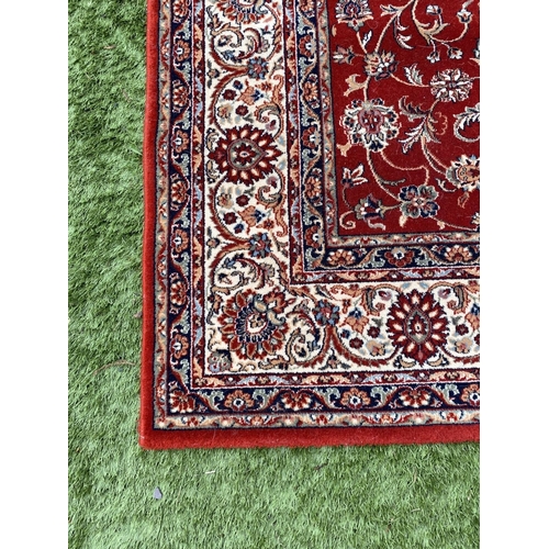 313 - A VIBRANT TURKISH STYLE RUG, excellent quality, the centre with foliate designs on red ground, surro... 