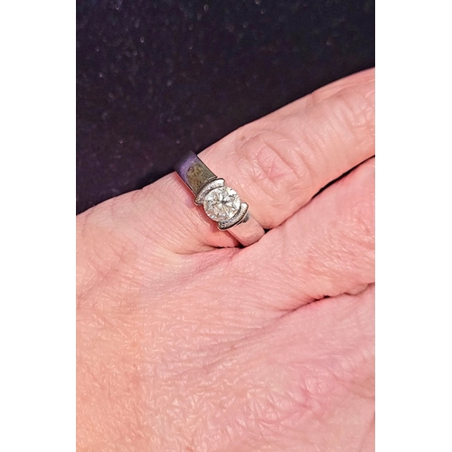 35 - AN 18CT WHITE GOLD SOLITAIRE RING, the stunning ½ carat diamond is held in a floating setting in a g... 