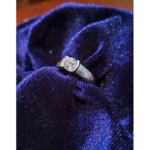 35 - AN 18CT WHITE GOLD SOLITAIRE RING, the stunning ½ carat diamond is held in a floating setting in a g... 