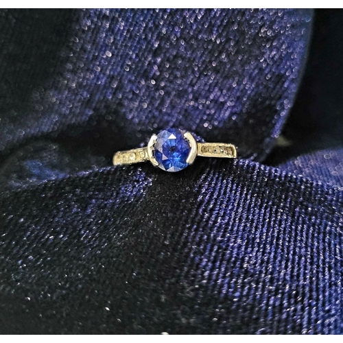 37 - AN 18CT WHITE GOLD DIAMOND & SAPPHIRE RING, with a round cut blue sapphire in a raised setting, with... 