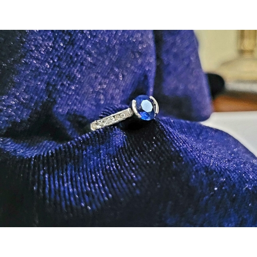 37 - AN 18CT WHITE GOLD DIAMOND & SAPPHIRE RING, with a round cut blue sapphire in a raised setting, with... 