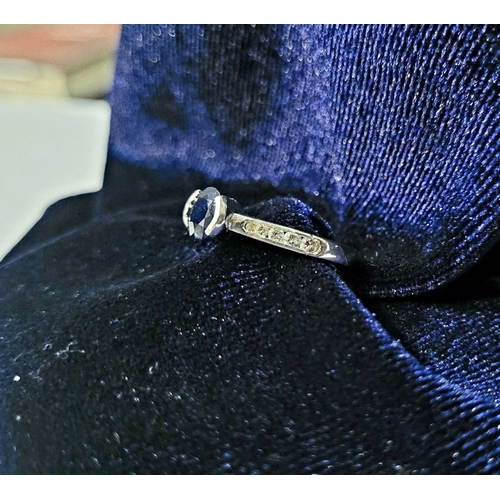 37 - AN 18CT WHITE GOLD DIAMOND & SAPPHIRE RING, with a round cut blue sapphire in a raised setting, with... 