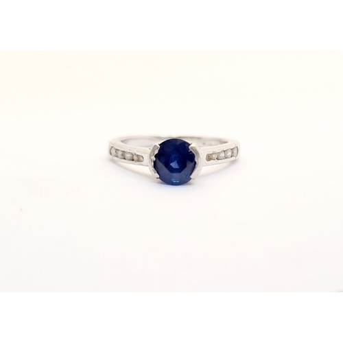 37 - AN 18CT WHITE GOLD DIAMOND & SAPPHIRE RING, with a round cut blue sapphire in a raised setting, with... 