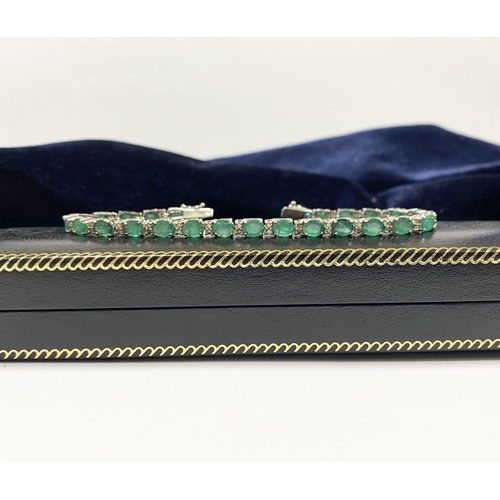 4 - AN 18CT WHITE GOLD EMERALD & DIAMOND TENNIS BRACELET, set with oval cut emeralds separated by two ro... 