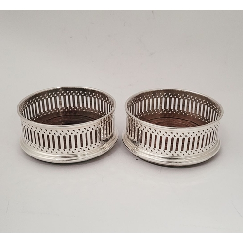 40 - A FINE PAIR OF 20TH CENTURY SILVER WINE COASTERS, with pierced decoration to the raised gallery side... 