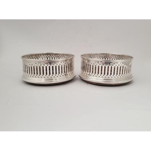 40 - A FINE PAIR OF 20TH CENTURY SILVER WINE COASTERS, with pierced decoration to the raised gallery side... 