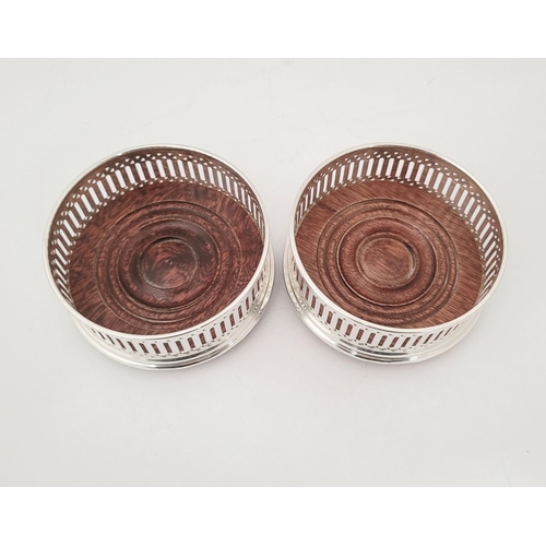 40 - A FINE PAIR OF 20TH CENTURY SILVER WINE COASTERS, with pierced decoration to the raised gallery side... 