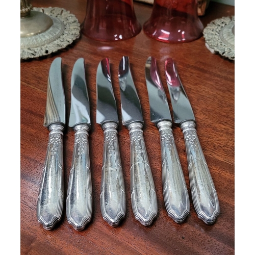 46 - A GOOD SET OF SIX LATE 19TH CENTURY FRENCH SILVER HANDLED DINNER KNIVES, the handles decorated with ... 