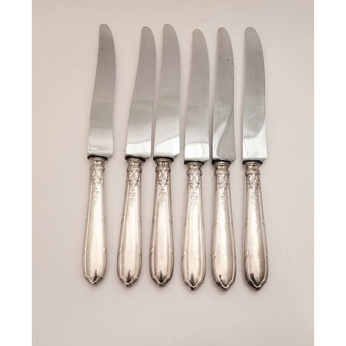 46 - A GOOD SET OF SIX LATE 19TH CENTURY FRENCH SILVER HANDLED DINNER KNIVES, the handles decorated with ... 