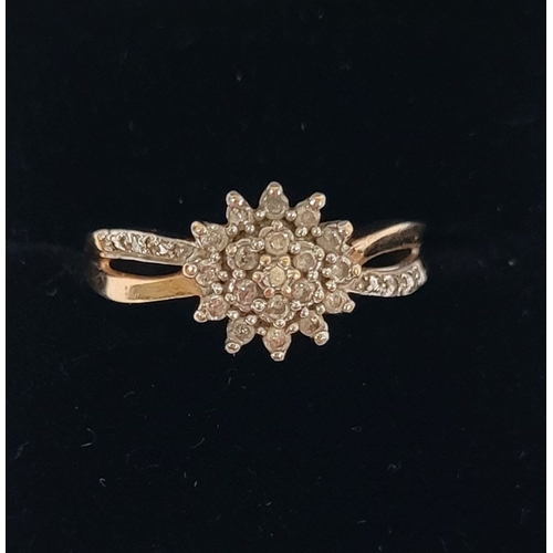 61 - A STRIKING 9CT YELLOW GOLD DIAMOND CLUSTER RING, with central round cut diamond surrounded by two ro... 