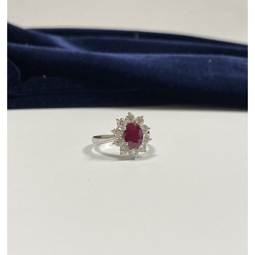 64 - AN 18CT WHITE GOLD BURMESE RUBY & DIAMOND CLUSTER RING, with central oval cut Burmese ruby in four c... 