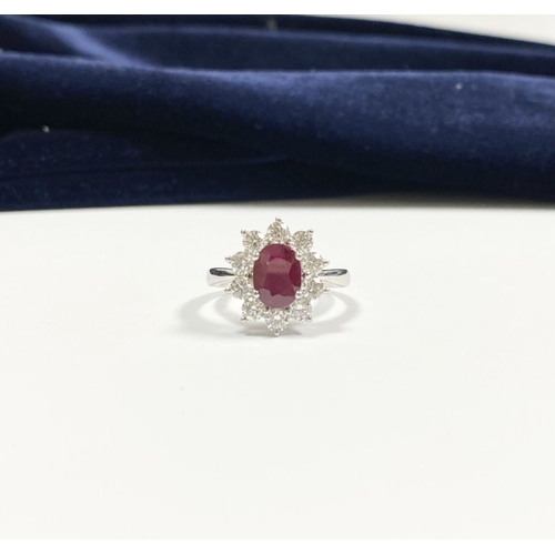 64 - AN 18CT WHITE GOLD BURMESE RUBY & DIAMOND CLUSTER RING, with central oval cut Burmese ruby in four c... 