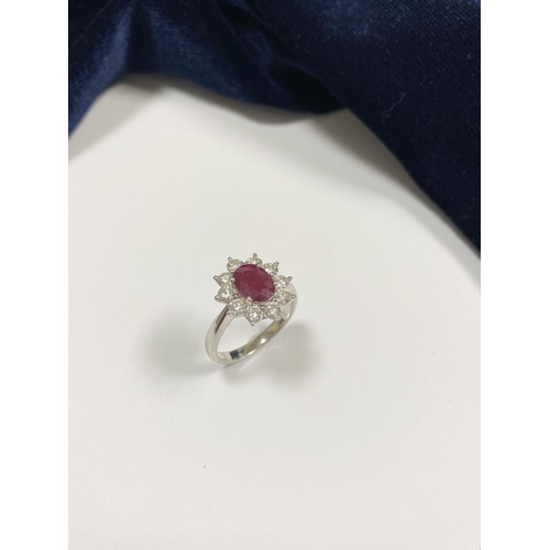 64 - AN 18CT WHITE GOLD BURMESE RUBY & DIAMOND CLUSTER RING, with central oval cut Burmese ruby in four c... 