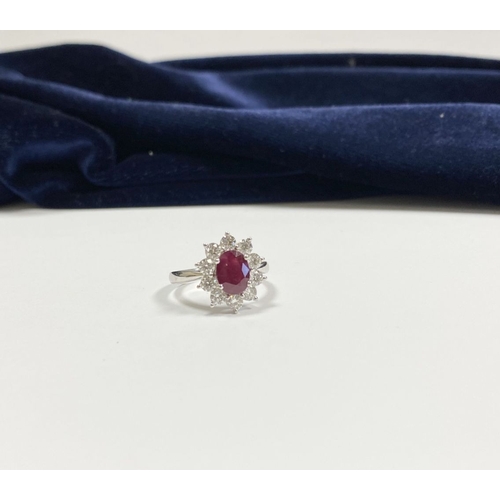 64 - AN 18CT WHITE GOLD BURMESE RUBY & DIAMOND CLUSTER RING, with central oval cut Burmese ruby in four c... 