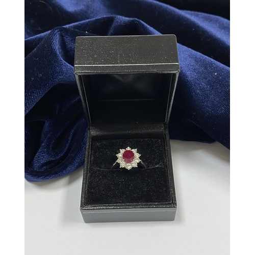 64 - AN 18CT WHITE GOLD BURMESE RUBY & DIAMOND CLUSTER RING, with central oval cut Burmese ruby in four c... 