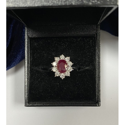 64 - AN 18CT WHITE GOLD BURMESE RUBY & DIAMOND CLUSTER RING, with central oval cut Burmese ruby in four c... 