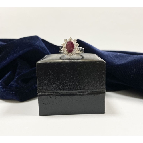 64 - AN 18CT WHITE GOLD BURMESE RUBY & DIAMOND CLUSTER RING, with central oval cut Burmese ruby in four c... 