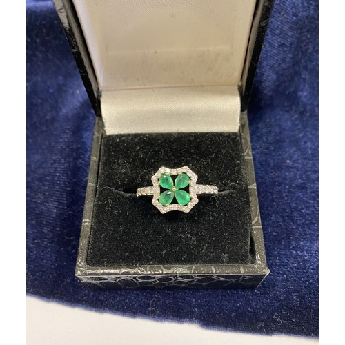 72 - A 14CT GOLD EMERALD & DIAMOND VAN CLEEF STYLE RING, with four central pear cut emeralds surrounded b... 