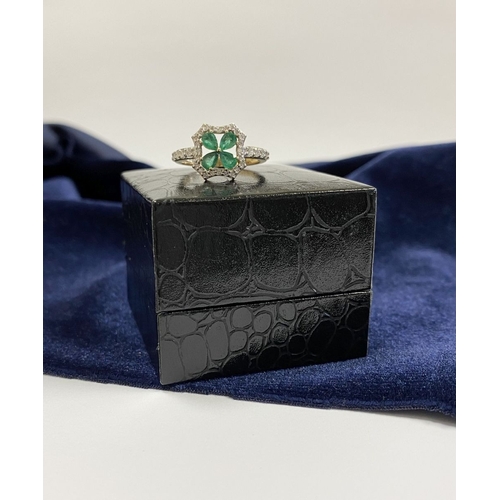 72 - A 14CT GOLD EMERALD & DIAMOND VAN CLEEF STYLE RING, with four central pear cut emeralds surrounded b... 