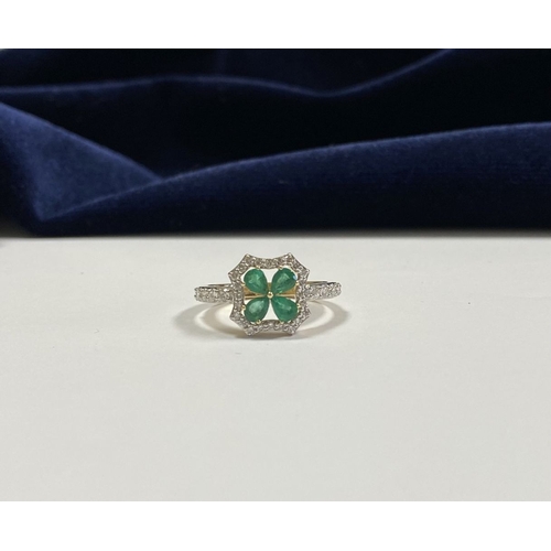 72 - A 14CT GOLD EMERALD & DIAMOND VAN CLEEF STYLE RING, with four central pear cut emeralds surrounded b... 