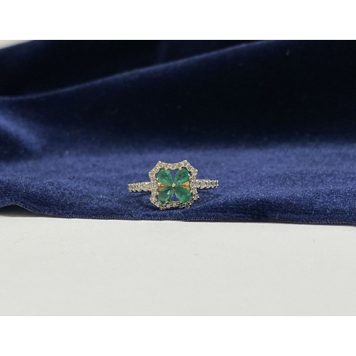 72 - A 14CT GOLD EMERALD & DIAMOND VAN CLEEF STYLE RING, with four central pear cut emeralds surrounded b... 