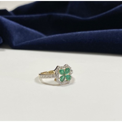 72 - A 14CT GOLD EMERALD & DIAMOND VAN CLEEF STYLE RING, with four central pear cut emeralds surrounded b... 