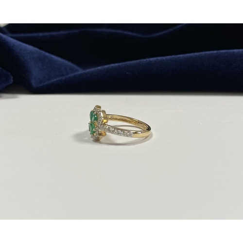 72 - A 14CT GOLD EMERALD & DIAMOND VAN CLEEF STYLE RING, with four central pear cut emeralds surrounded b... 