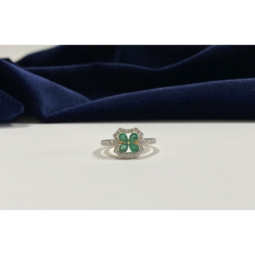 72 - A 14CT GOLD EMERALD & DIAMOND VAN CLEEF STYLE RING, with four central pear cut emeralds surrounded b... 