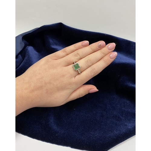 72 - A 14CT GOLD EMERALD & DIAMOND VAN CLEEF STYLE RING, with four central pear cut emeralds surrounded b... 