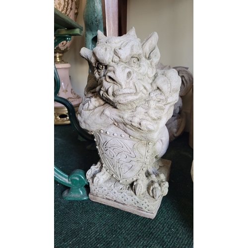 76 - A STONE GARDEN ORNAMENT IN THE FORM OF GARGOYLE WITH SHIELD, dimensions: 39cm high approx.