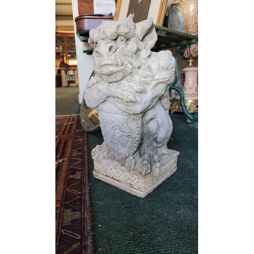 76 - A STONE GARDEN ORNAMENT IN THE FORM OF GARGOYLE WITH SHIELD, dimensions: 39cm high approx.