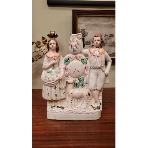 77 - A 19TH CENTURY STAFFORDSHIRE FLAT-BACKED FIGURAL GROUP, depicting a man & woman in traditional dress... 