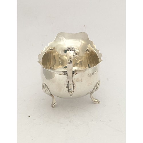 89 - AN ELEGANT EDWARD VII SILVER SAUCE BOAT, by William Aitken, Vyse Street, Birmingham c.1906. With gad... 