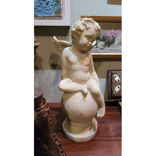 266 - A NICELY DETAILED PLASTER CHERUB STATUE, cherub/putti seated on globe on circular platform base. Dim... 