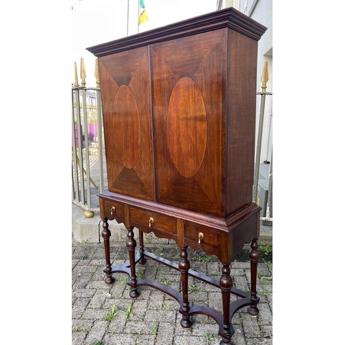 104 - AN EXCELLENT MAHOGANY WILLIAM & MARY CABINET ON STAND, with moulded cornice above two crossbanded do... 